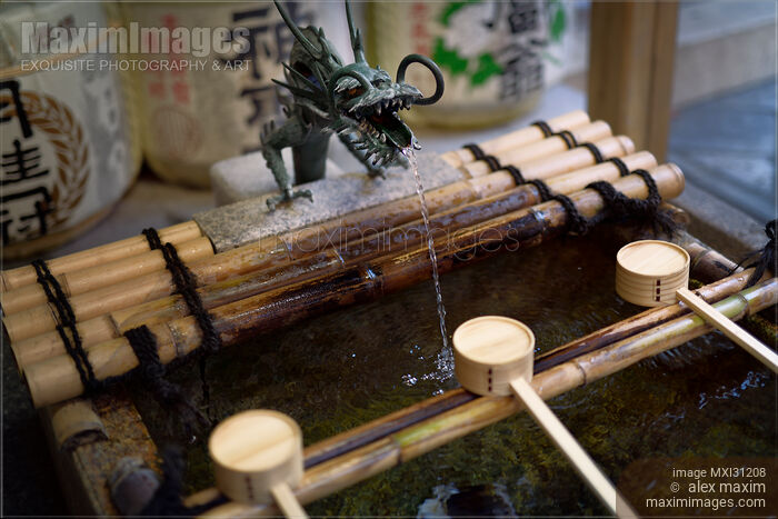 Dragon head Chozuya water purifying basin with bamboo dippers at a temple in Kyoto Stock photo of Dragon head Chozuya water purifying basin with bamboo dippers at a temple in Kyoto Buy commercial use license at MaximImages