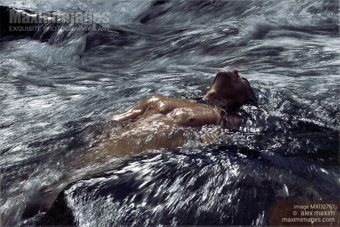 Dramatic portrait of a man with bare torso submerged in rushing river water Stock photo of Dramatic portrait of a man with bare torso submerged in rushing river water Buy commercial use license at MaximImages