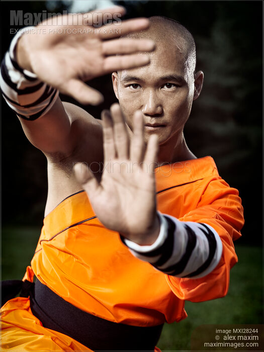 Stock photo of Dramatic portrait of a Shaolin warrior monk practicing Kung Fu Buy commercial use license at MaximImages