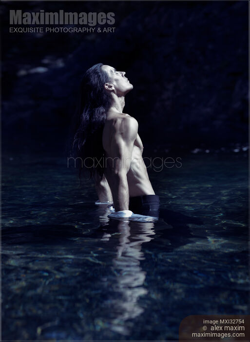 Dramatic portrait of a shirtless man with bare torso standing in water in pants Stock photo of Dramatic portrait of a shirtless man with bare torso standing in water in pants Buy commercial use license at MaximImages