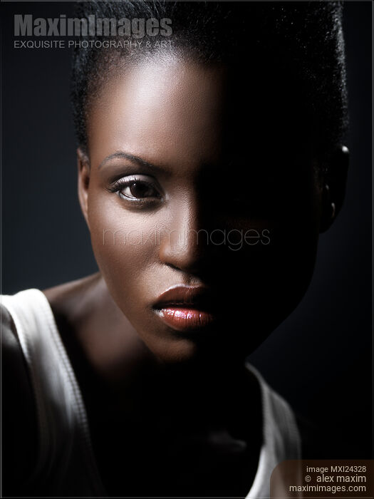 Stock photo of Dramatic portrait of a young black african american woman face Buy commercial use license at MaximImages