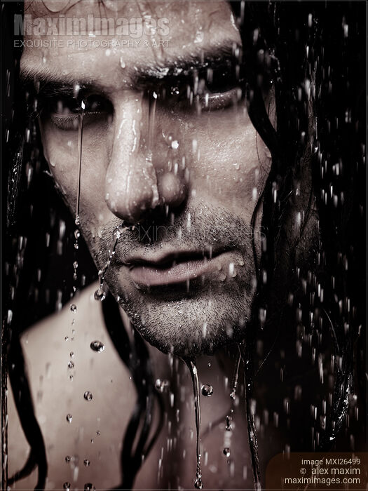 Stock photo of Dramatic portrait of young man wet face with long hair Buy commercial use license at MaximImages