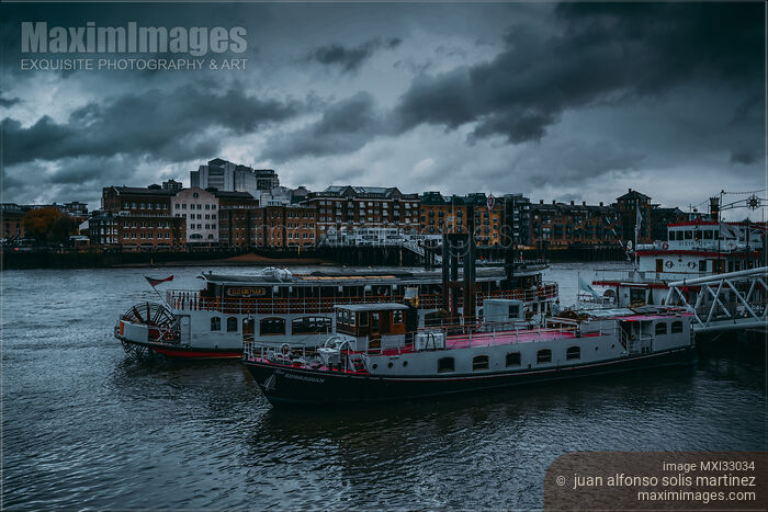 Dramatic scenery of cruise boats and restaurants on river Thames in London Stock photo of Dramatic scenery of cruise boats and restaurants on river Thames in London Buy commercial use license at MaximImages