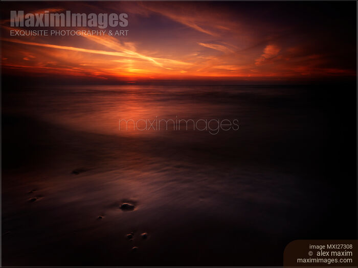 Stock photo of Dramatic sunset over dark water of lake Huron Buy commercial use license at MaximImages