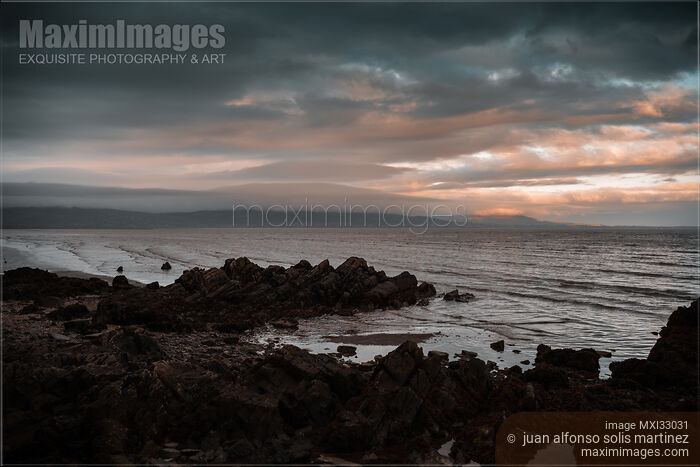 Dramatic view of a rocky sea shore in Blackrock Co. Louth Ireland at sunset Stock photo of Dramatic view of a rocky sea shore in Blackrock Co. Louth Ireland at sunset Buy commercial use license at MaximImages