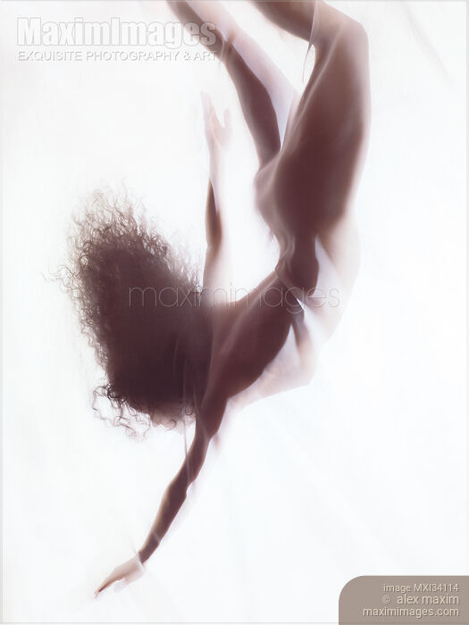 Stock photo of Dreamy ethereal silhouette of a nude woman falling gracefully through white glowing mist behind the veil Buy commercial use license at MaximImages