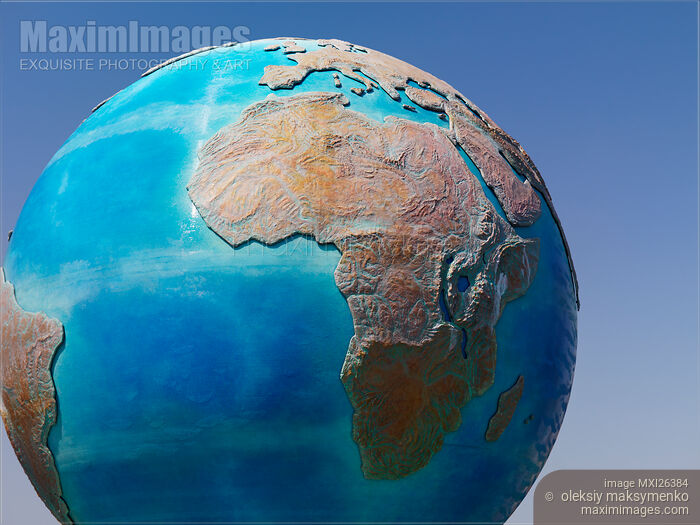 Stock photo of Earth globe sculpture over blue sky Buy commercial use license at MaximImages
