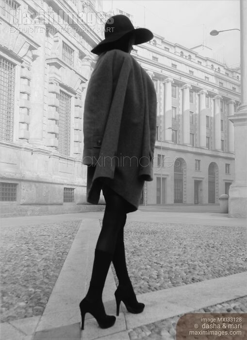 Elegant incognito woman on a city street wearing a fashionable coat, black stockings, high heels and a hat Stock photo of Elegant incognito woman on a city street wearing a fashionable coat, black stockings, high heels and a hat Buy commercial use license at MaximImages