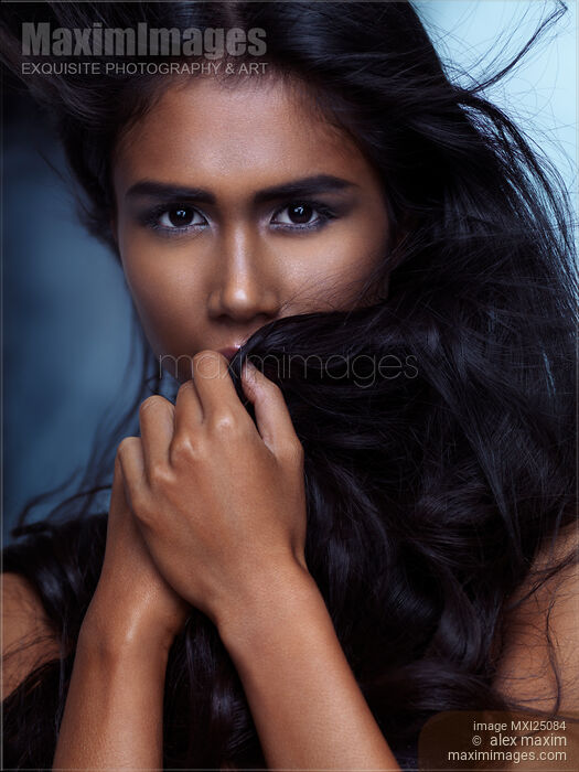 Emotional beauty portrait of a woman covering her faice with hair Stock photo of Emotional beauty portrait of a woman covering her faice with hair Buy commercial use license at MaximImages