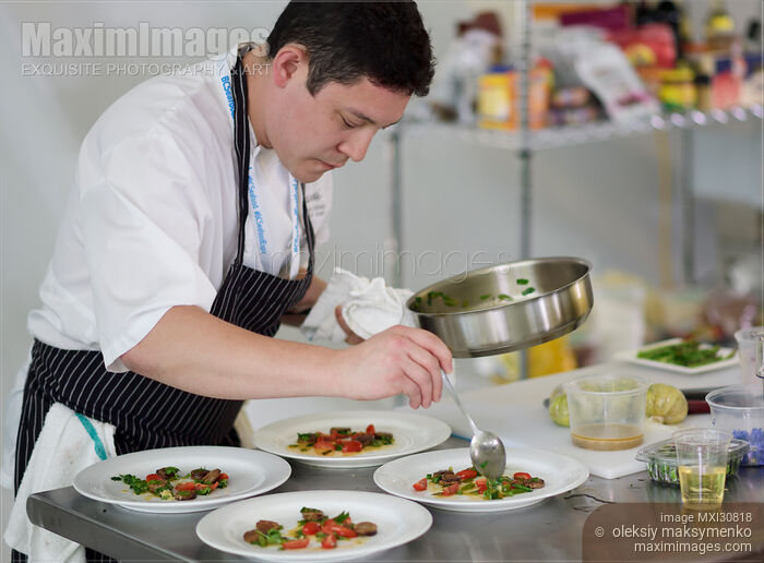 Stock photo of Executive Chef Quang Dang preparing a gourmet competition meal at BC Seafood Festival Buy commercial use license at MaximImages