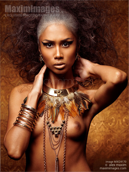 Exotic beauty portrait of a woman wearing feathers and accessories Stock photo of Exotic beauty portrait of a woman wearing feathers and accessories Buy commercial use license at MaximImages