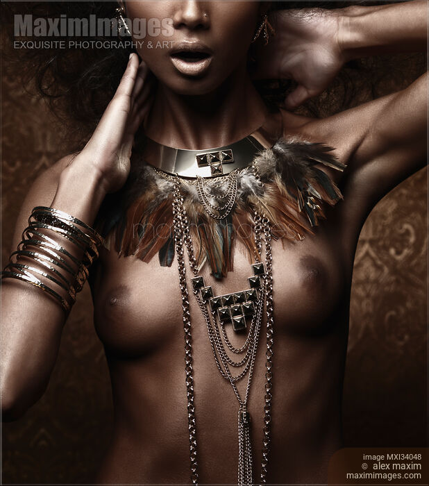 Exotic nude aboriginal woman with tribal feather necklace and jewelry on her bare chest Stock photo of Exotic nude aboriginal woman with tribal feather necklace and jewelry on her bare chest Buy commercial use license at MaximImages