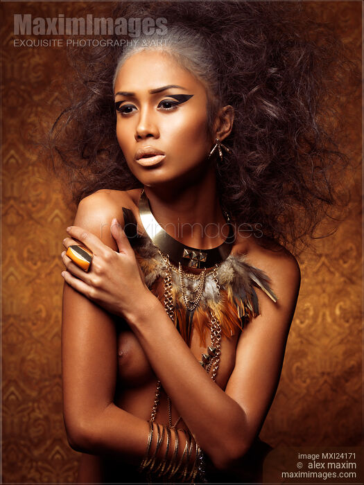 Exotic portrait of a beautiful woman with bird themed styling Stock photo of Exotic portrait of a beautiful woman with bird themed styling Buy commercial use license at MaximImages