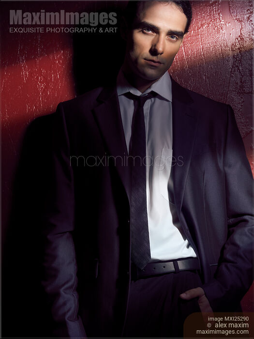 Expressive portrait of a man wearing a suit in dramatic light Stock photo of Expressive portrait of a man wearing a suit in dramatic light Buy commercial use license at MaximImages