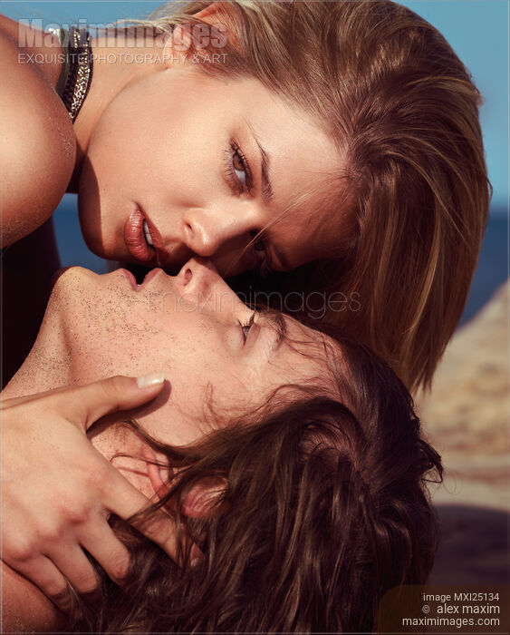 Stock photo of Faces of young couple kissing at the beach Buy commercial use license at MaximImages