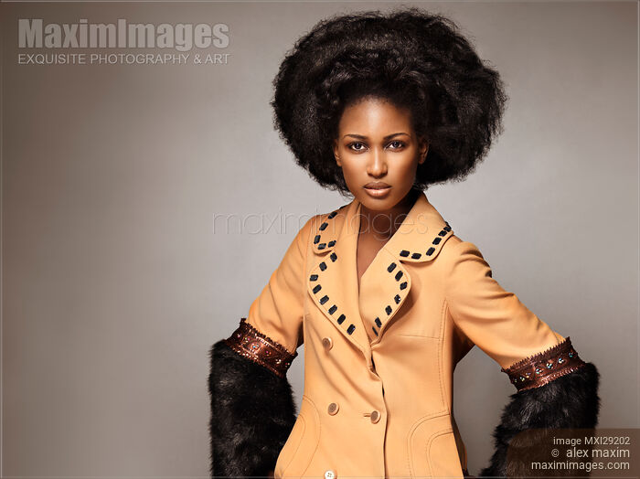 Fashion beauty portrait of a black african model wearing a coat with fur Stock photo of Fashion beauty portrait of a black african model wearing a coat with fur Buy commercial use license at MaximImages
