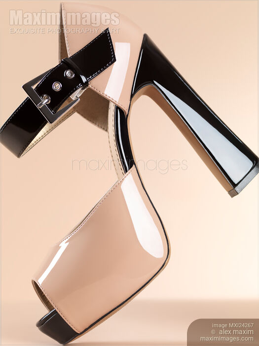 Stock photo of Fashionable high heel shoe on beige Buy commercial use license at MaximImages