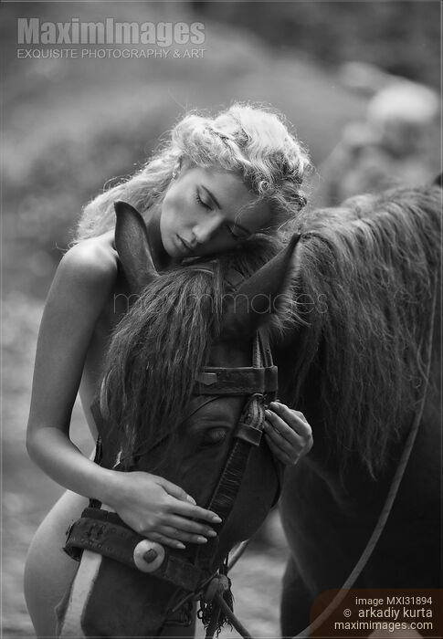Fine art black and white photograph of a naked woman hugging a horse in the forest Stock photo of Fine art black and white photograph of a naked woman hugging a horse in the forest Buy commercial use license at MaximImages