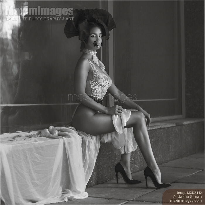Stock photo of Fine art fashion-boudoir portrait of a sexy lady in lace lingerie and high heels with a butterfly on her lips Buy commercial use license at MaximImages