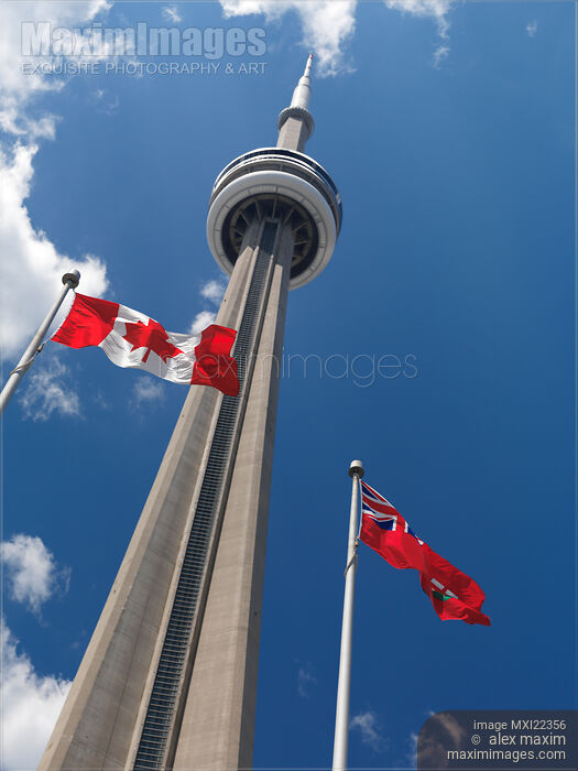 Stock photo of Flags Flying in Front of CN Tower Buy commercial use license at MaximImages
