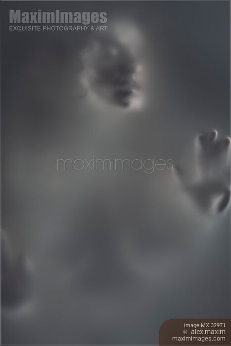 Stock photo of Ghostly gray woman face behind a hazy blurry suffocating fog Suffering and sensuality fine art concept Buy commercial use license at MaximImages