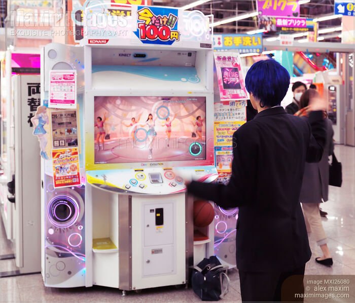 Girl playing dance station slot machine at arcade Stock photo of Girl playing dance station slot machine at arcade Buy commercial use license at MaximImages