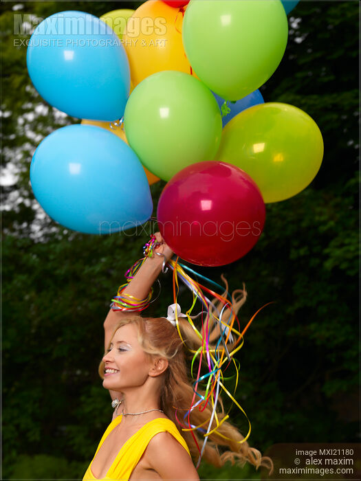 Stock photo of Girl with Air Balloons Buy commercial use license at MaximImages