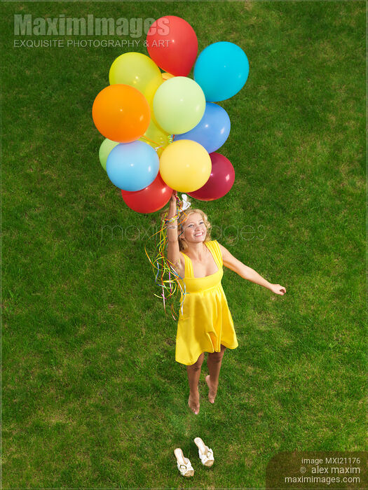 Stock photo of Girl with air balloons in mid-air Buy commercial use license at MaximImages