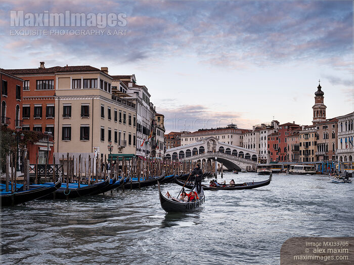 Stock photo of Gondolas at Venice Grand Canal with beautiful historic Venetian architecture and the Rialto Bridge Buy commercial use license at MaximImages