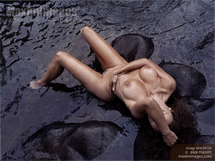 Gorgeous nude woman lying in dark sea water. Artistic erotic photograph view from above. Stock photo of Gorgeous nude woman lying in dark sea water. Artistic erotic photograph view from above. Buy commercial use license at MaximImages