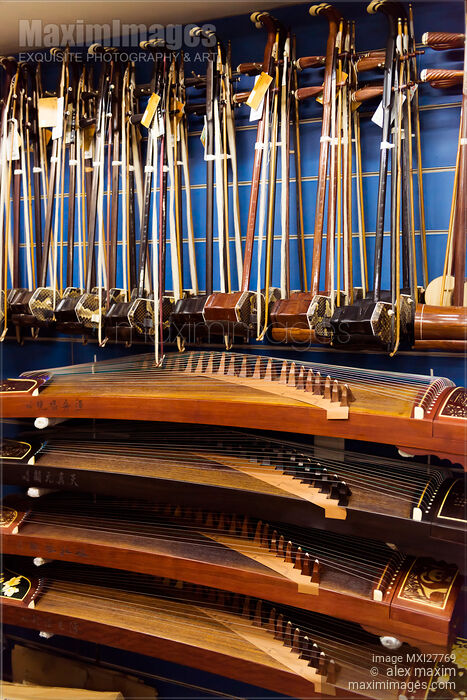 Stock photo of Guzheng and Erhu instruments in a store Buy commercial use license at MaximImages
