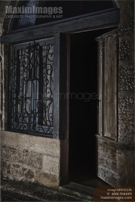 Half open entrance door showing dark house interior from the street at night Stock photo of Half open entrance door showing dark house interior from the street at night Buy commercial use license at MaximImages