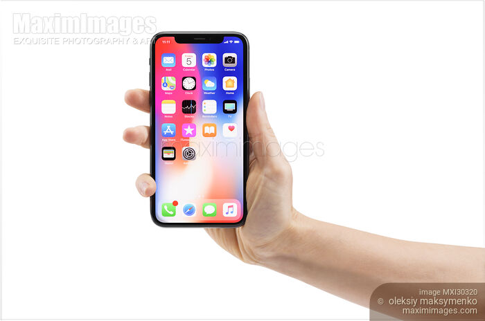 Stock photo of Hand holding Apple iPhone X smartphone isolated on white Buy commercial use license at MaximImages