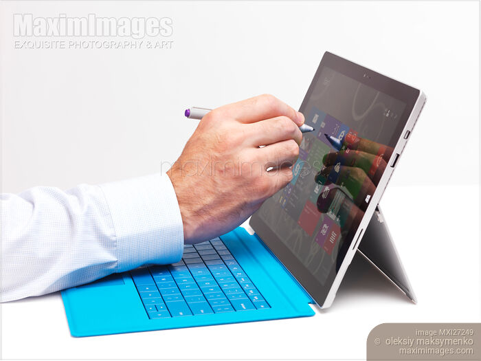 Hand with a pen touching Microsoft tablet Surface Pro 3 display Stock photo of Hand with a pen touching Microsoft tablet Surface Pro 3 display Buy commercial use license at MaximImages