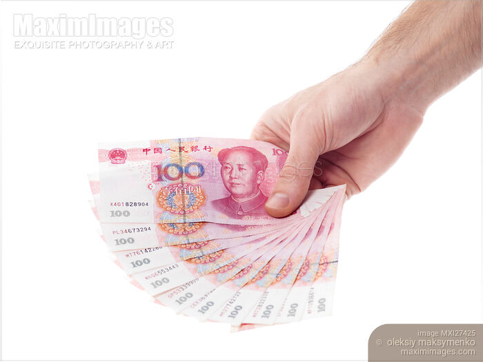 Stock photo of Hand with Chinese Yuan money bills Buy commercial use license at MaximImages
