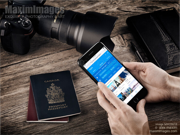 Stock photo of Hands with iPhone 7 displaying flight information Buy commercial use license at MaximImages