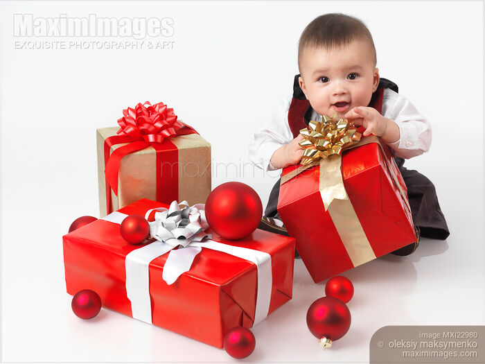 Happy Baby Boy Opening Christmas Presents Stock photo of Happy Baby Boy Opening Christmas Presents Buy commercial use license at MaximImages
