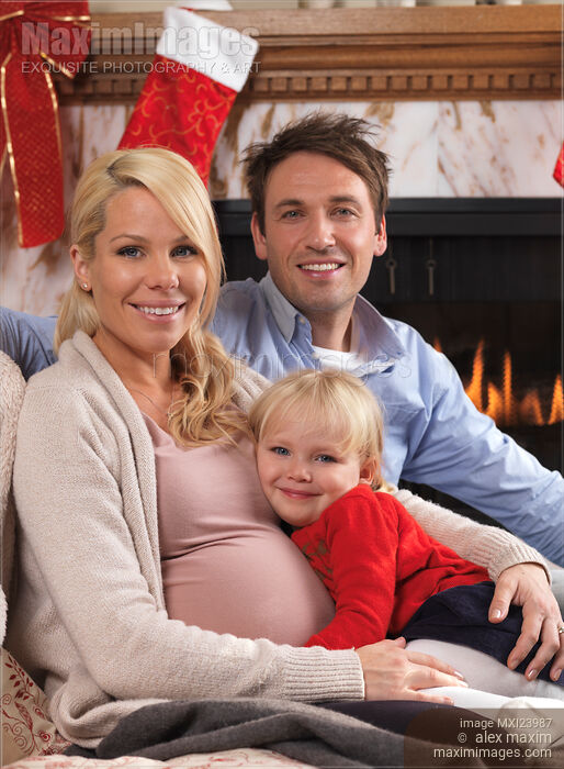 Happy family together at home on Christmas eve Stock photo of Happy family together at home on Christmas eve Buy commercial use license at MaximImages
