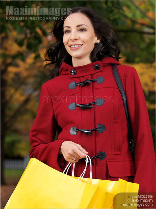 Happy Young Woman Walking with Shopping Bags Stock photo of Happy Young Woman Walking with Shopping Bags Buy commercial use license at MaximImages