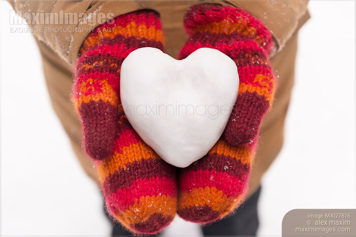 Heart made of snow in woman hands Stock photo of Heart made of snow in woman hands Buy commercial use license at MaximImages
