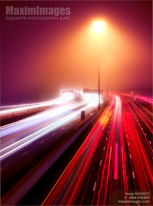 Stock photo of Highway traffic light trails in fog at nighttime Buy commercial use license at MaximImages