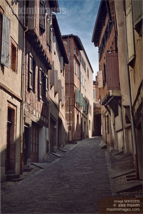 Stock photo of Historic medieval houses along a narrow street of the old town of Albi Southern France Buy commercial use license at MaximImages