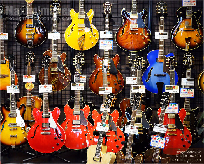 Stock photo of Hollow-body electric guitars in store Buy commercial use license at MaximImages