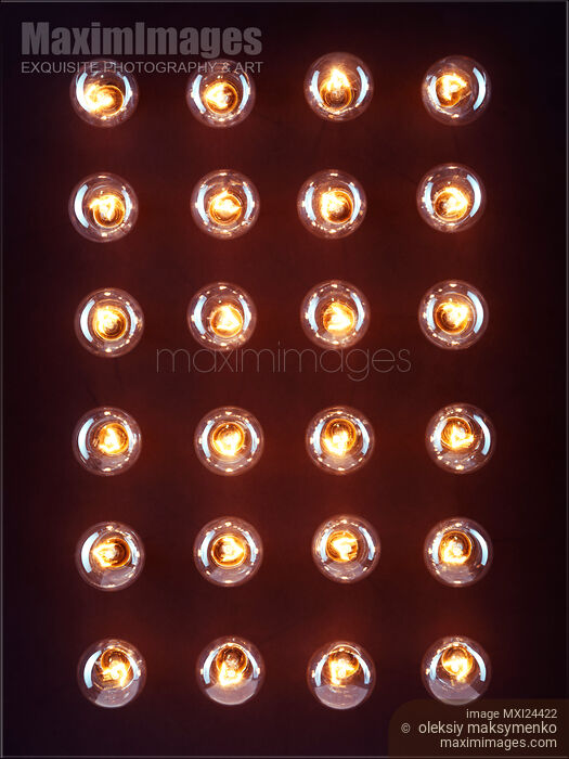 Stock photo of Illuminated light bulbs on black background Buy commercial use license at MaximImages