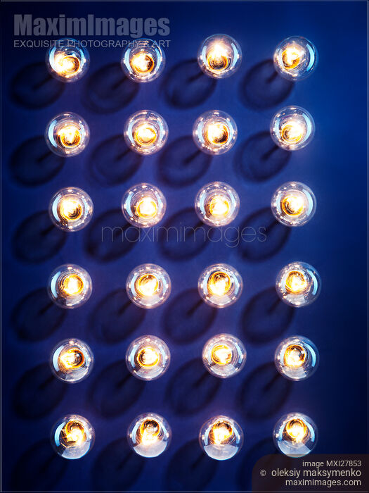 Illuminated light bulbs on blue background Stock photo of Illuminated light bulbs on blue background Buy commercial use license at MaximImages