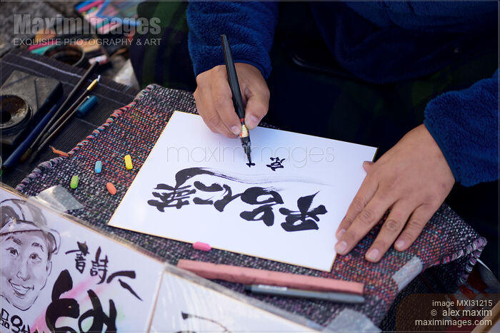 Stock photo of Japanese calligrapher street artist writing name in Kanji characters Buy commercial use license at MaximImages