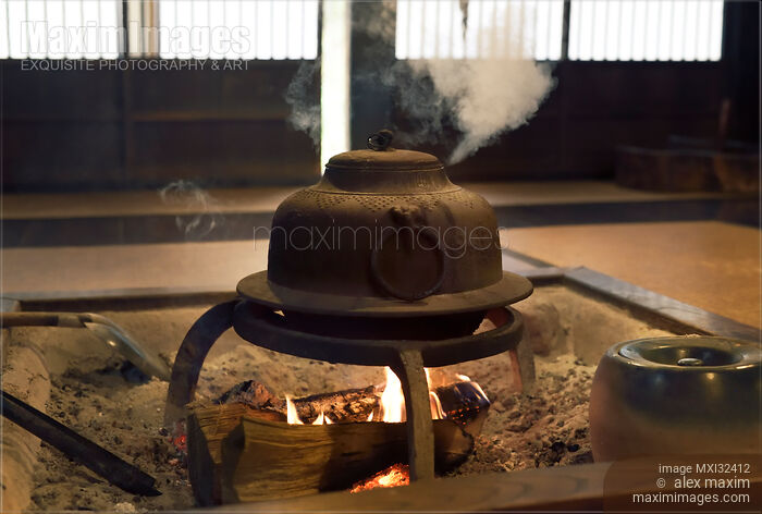 Stock photo of Japanese cast iron kettle steaming on fire in a sunken hearth Irori Shirakawa-go village Japan Buy commercial use license at MaximImages