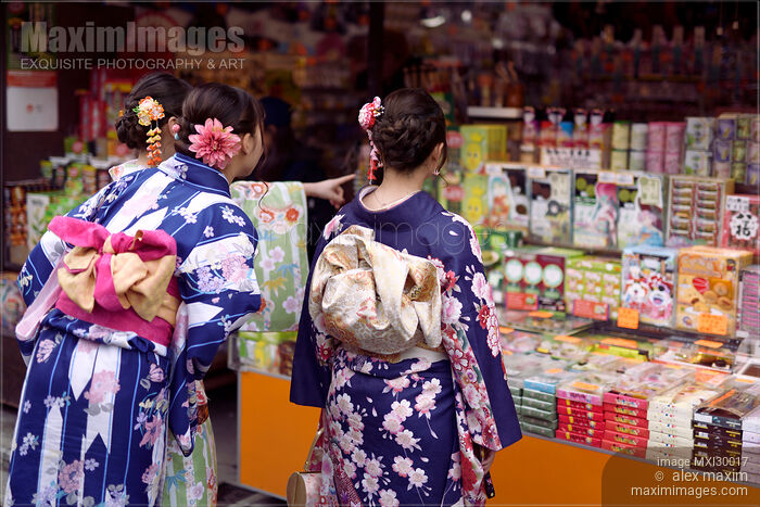 Japanese girls in bright Yukatas stopped by a shop with traditional local Kyoto treats Stock photo of Japanese girls in bright Yukatas stopped by a shop with traditional local Kyoto treats Buy commercial use license at MaximImages
