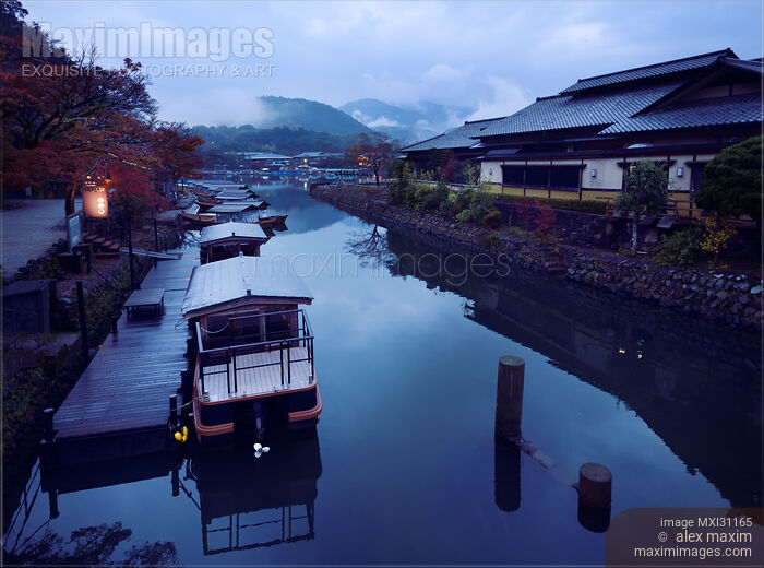 Japanese sightseeing boats in a misty autumn scenery at Katsura River with fog covered mountains of Arashiyama Stock photo of Japanese sightseeing boats in a misty autumn scenery at Katsura River with fog covered mountains of Arashiyama Buy commercial use license at MaximImages