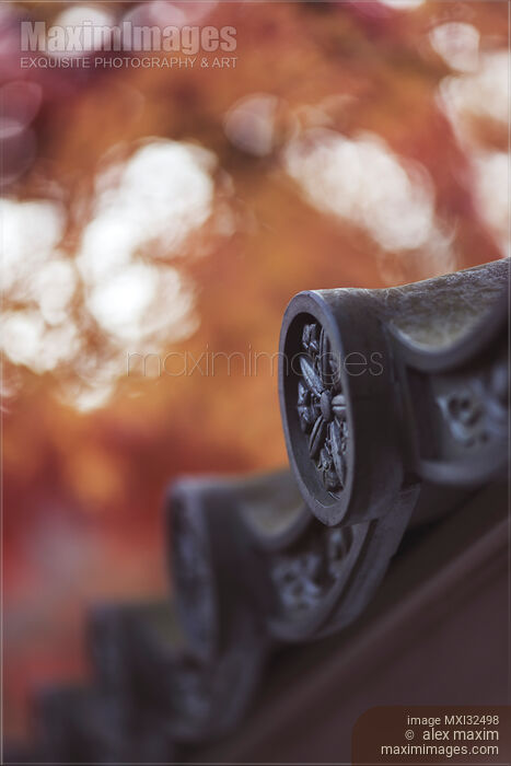 Stock photo of Japanese temple roof eaves with ornamental clay roofing tile Kawara closeup of details Buy commercial use license at MaximImages